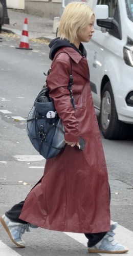 tailored black trousers and a striking red leather trench coat